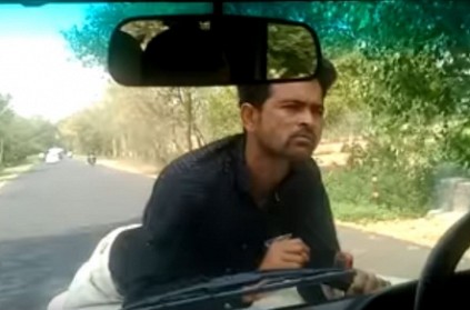 Video of protester hanging on to car bonnet as driver drives on