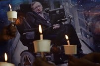 Children holding candles to honour the passing of scientist Stephen Hawking