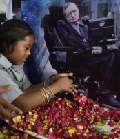 Children holding candles to honour the passing of scientist Stephen Hawking
